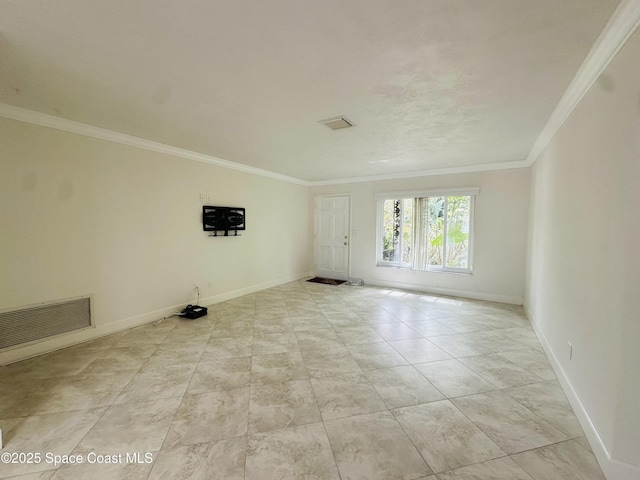 unfurnished room featuring ornamental molding, visible vents, and baseboards