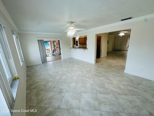 unfurnished living room featuring baseboards, ceiling fan, visible vents, and crown molding