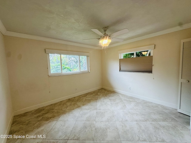 unfurnished room with ceiling fan, baseboards, and crown molding