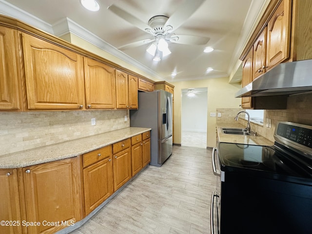 kitchen with ceiling fan, appliances with stainless steel finishes, crown molding, under cabinet range hood, and a sink