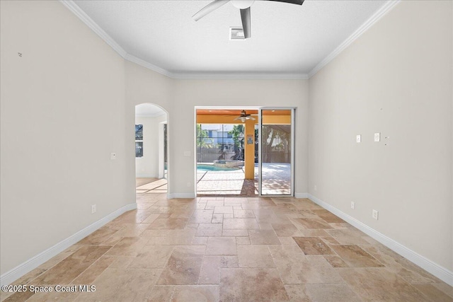 spare room featuring ceiling fan, visible vents, baseboards, stone tile flooring, and crown molding