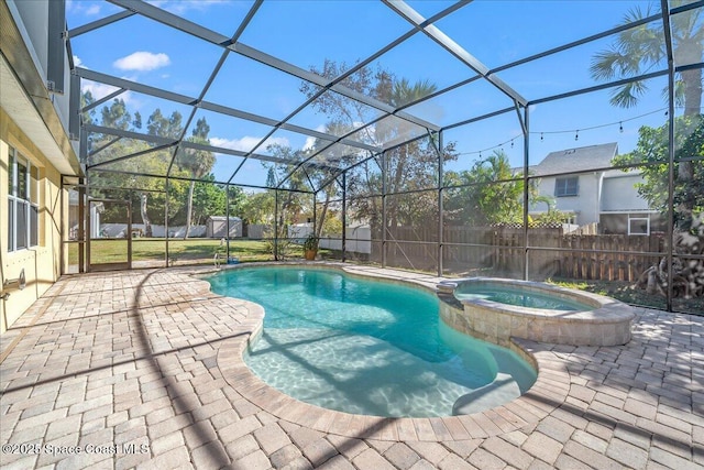 view of swimming pool with glass enclosure, a pool with connected hot tub, a fenced backyard, and a patio