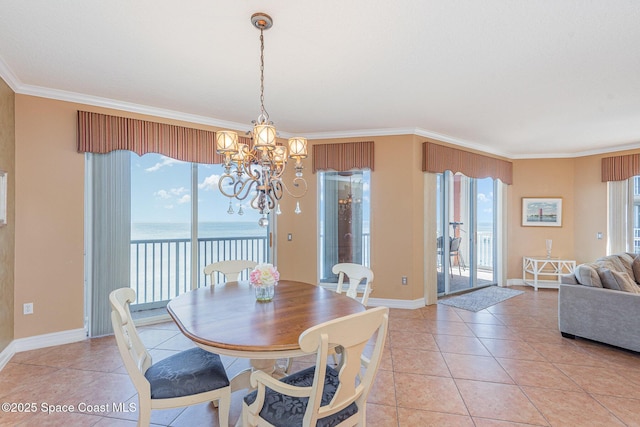 dining area with baseboards, ornamental molding, a water view, a notable chandelier, and light tile patterned flooring