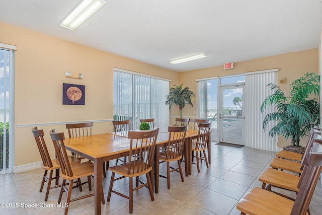 dining room featuring baseboards and light tile patterned floors