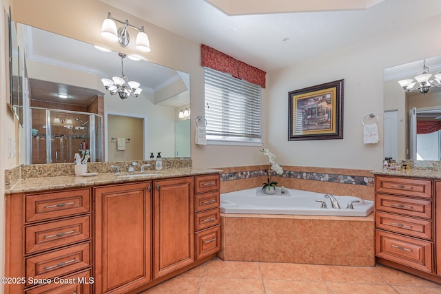 bathroom with tile patterned flooring, a notable chandelier, vanity, a shower stall, and crown molding