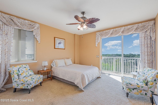 bedroom with access to exterior, carpet, multiple windows, and a ceiling fan