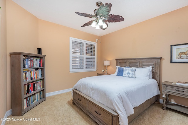 bedroom with light carpet, a ceiling fan, and baseboards