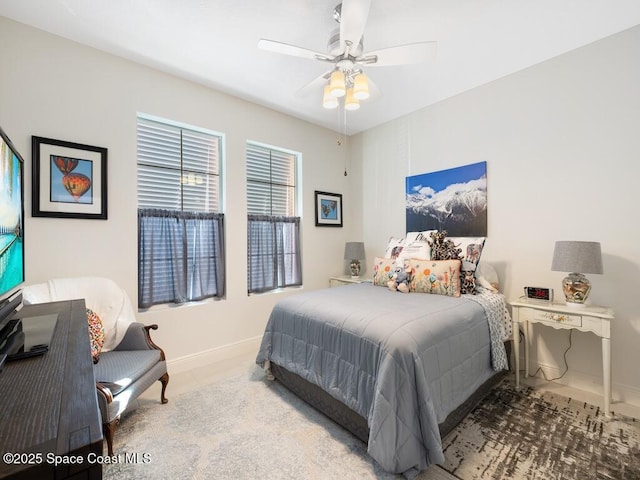 bedroom featuring ceiling fan, tile patterned flooring, and baseboards