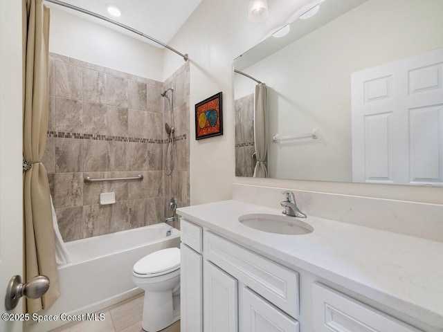 bathroom with toilet, shower / bath combo, and vanity