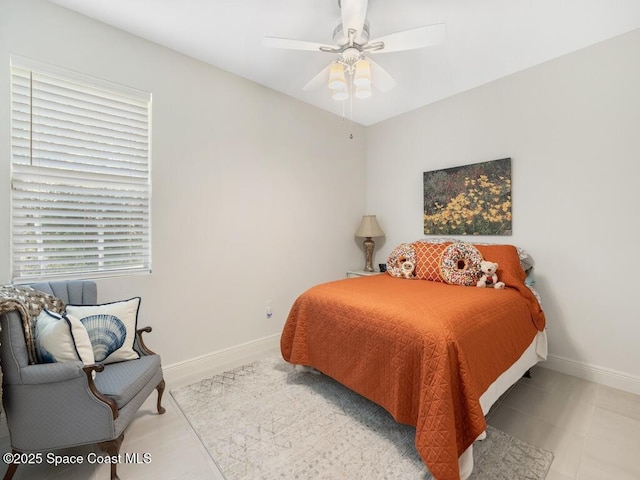 bedroom with baseboards and a ceiling fan