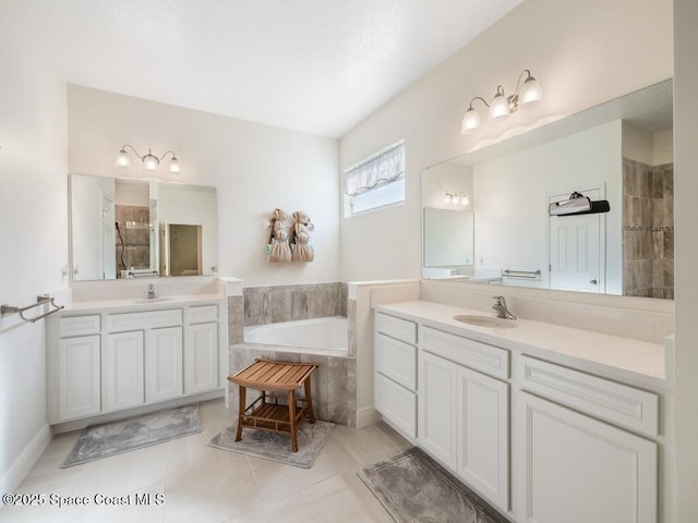 bathroom with two vanities, a garden tub, a sink, and a tile shower