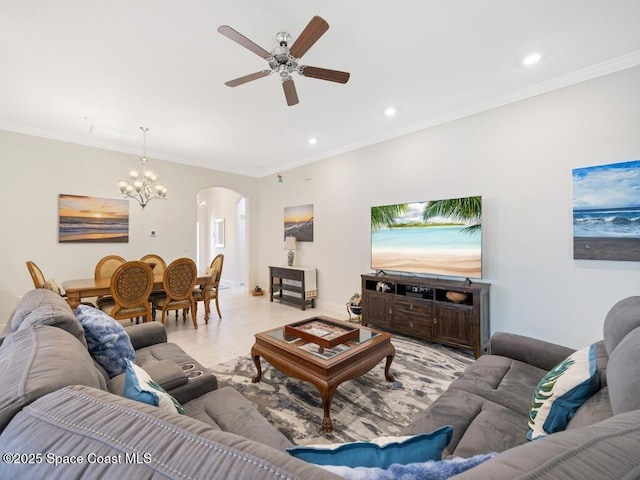 living area with light tile patterned floors, recessed lighting, arched walkways, crown molding, and ceiling fan with notable chandelier