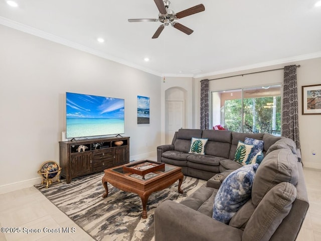 living room featuring baseboards, arched walkways, ceiling fan, ornamental molding, and recessed lighting