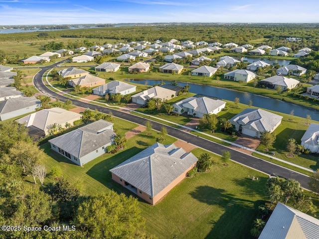 birds eye view of property with a water view and a residential view