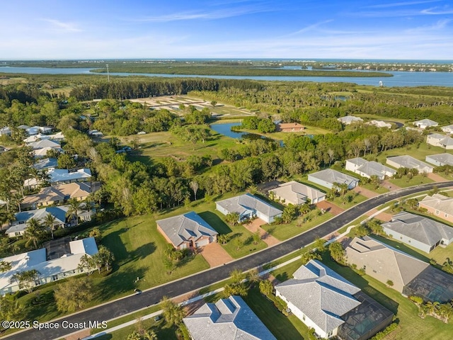 bird's eye view featuring a water view and a residential view