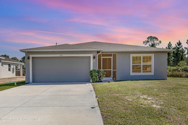 ranch-style home with a front lawn, concrete driveway, roof with shingles, stucco siding, and an attached garage