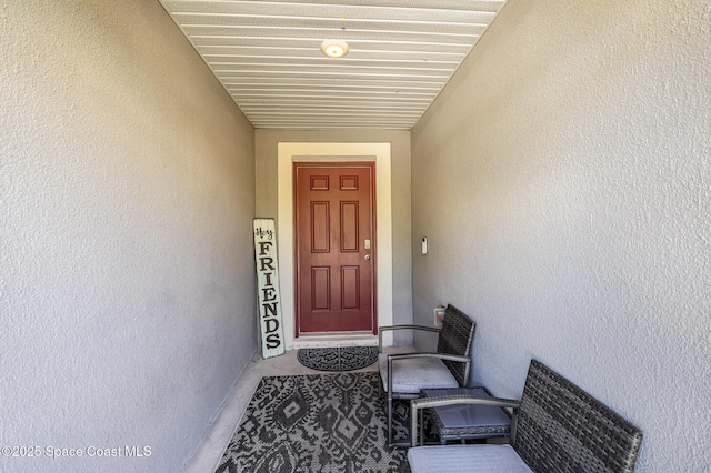 view of exterior entry with stucco siding