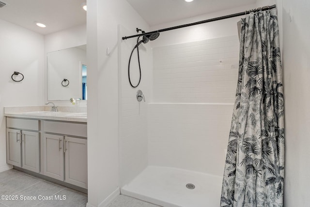 406 Alamo St, Palm Bay, FL 32909 - bathroom featuring double vanity, tiled shower, tile patterned flooring, and recessed lighting