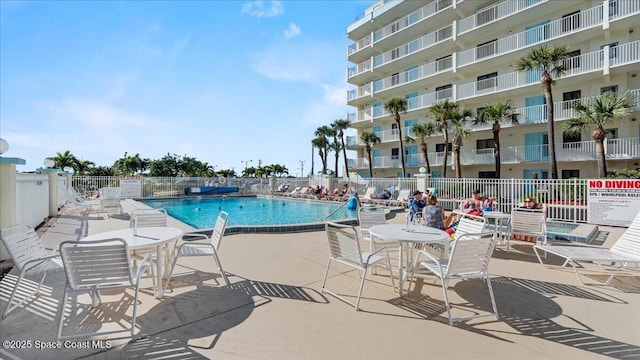 pool featuring a patio and fence