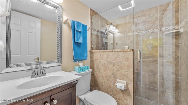 full bathroom with a stall shower, vanity, and toilet