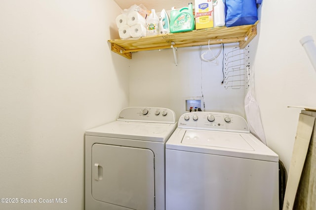 clothes washing area with washing machine and dryer and laundry area