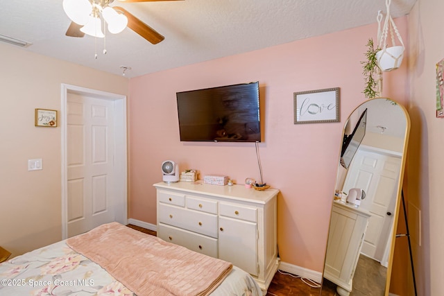 bedroom with baseboards, visible vents, and ceiling fan