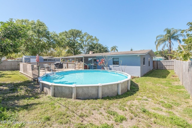 view of pool featuring a lawn, a fenced in pool, and a fenced backyard