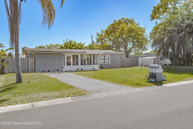 718 6th St, Merritt Island, FL 32953 - view of front of property with stucco siding and asphalt driveway