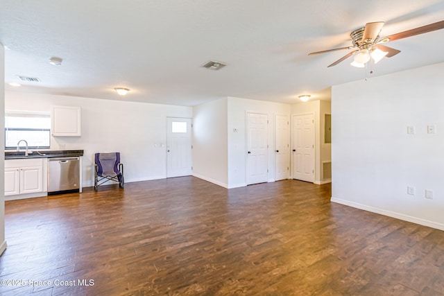 718 6th St, Merritt Island, FL 32953 - unfurnished living room with dark wood finished floors, ceiling fan, baseboards, and plenty of natural light