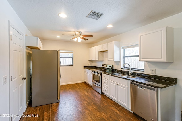 718 6th St, Merritt Island, FL 32953 - kitchen featuring appliances with stainless steel finishes, a sink, ceiling fan, white cabinets, and recessed lighting