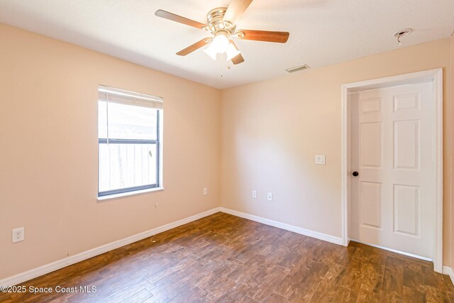 718 6th St, Merritt Island, FL 32953 - empty room with wood finished floors, ceiling fan, and baseboards