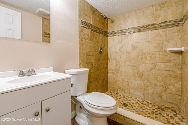 718 6th St, Merritt Island, FL 32953 - full bathroom with a textured ceiling, tiled shower, toilet, and vanity