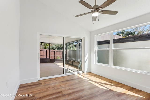 unfurnished sunroom featuring lofted ceiling and a ceiling fan