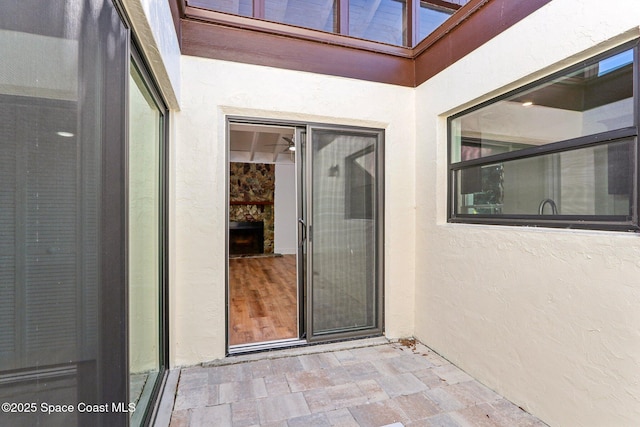 entrance to property featuring stucco siding