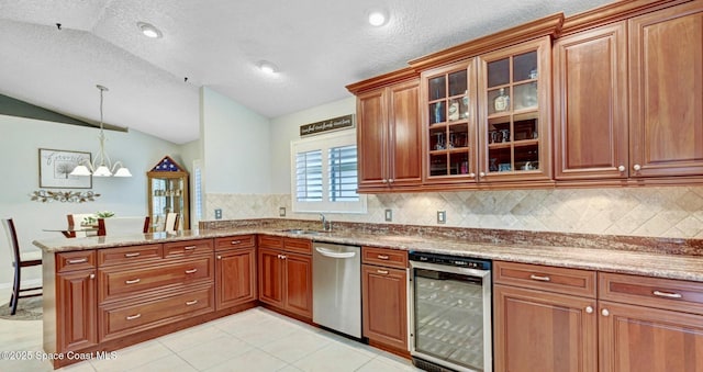 kitchen featuring beverage cooler, brown cabinets, dishwasher, and a sink