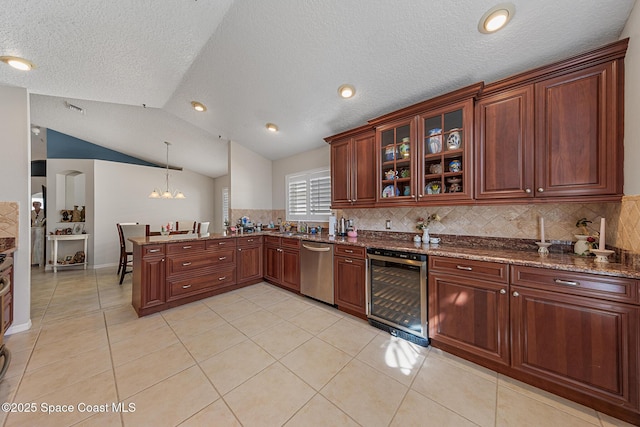 4983 Erin Ln, Melbourne, FL 32940 - kitchen with a peninsula, vaulted ceiling, wine cooler, dishwasher, and a chandelier