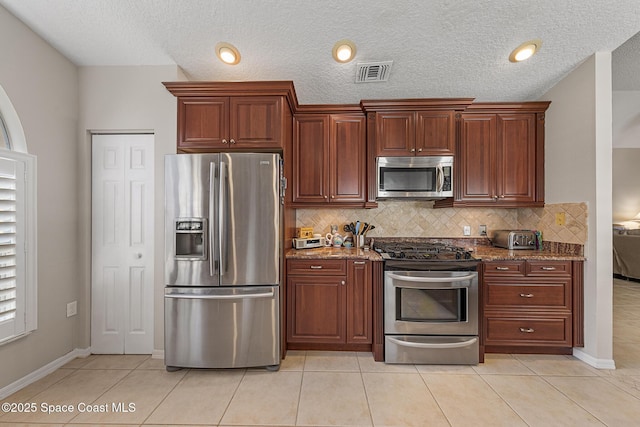 4983 Erin Ln, Melbourne, FL 32940 - kitchen with decorative backsplash, dark stone counters, visible vents, and appliances with stainless steel finishes