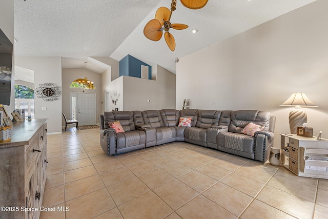 4983 Erin Ln, Melbourne, FL 32940 - living room featuring light tile patterned flooring, a textured ceiling, high vaulted ceiling, and a ceiling fan