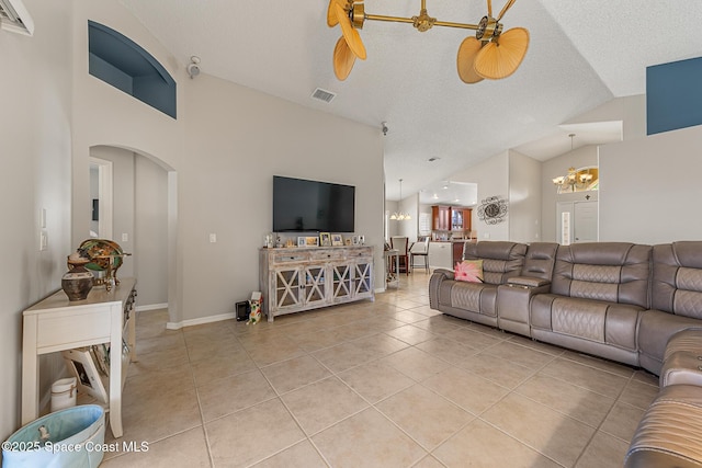 4983 Erin Ln, Melbourne, FL 32940 - living room with visible vents, a textured ceiling, arched walkways, an inviting chandelier, and light tile patterned floors