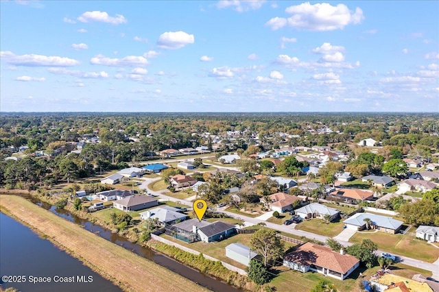 drone / aerial view featuring a residential view and a water view