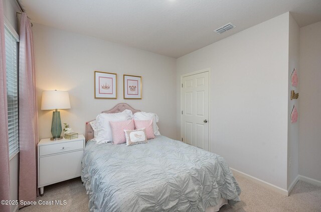 bedroom with baseboards, visible vents, and carpet flooring