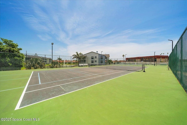 view of sport court with fence