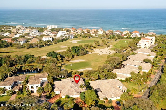 aerial view featuring a water view, view of golf course, and a residential view