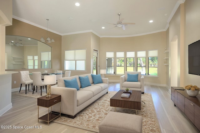 living room with light wood-type flooring, baseboards, and ornamental molding