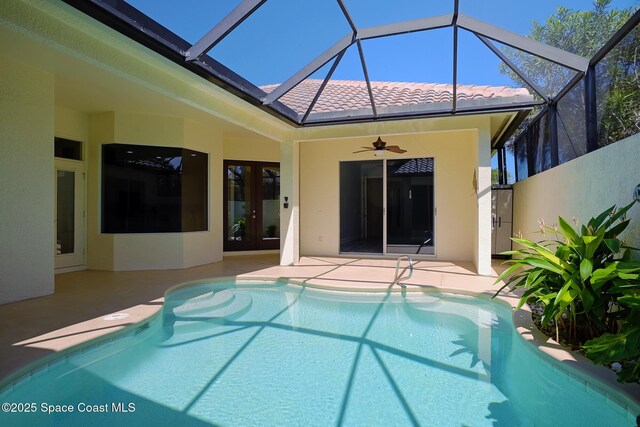 pool featuring a ceiling fan, french doors, glass enclosure, and a patio