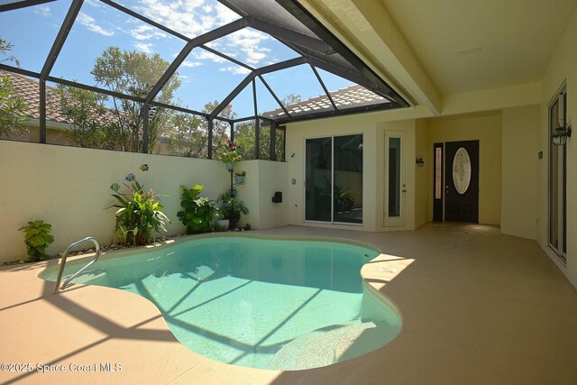 view of swimming pool with a fenced in pool, glass enclosure, and a patio