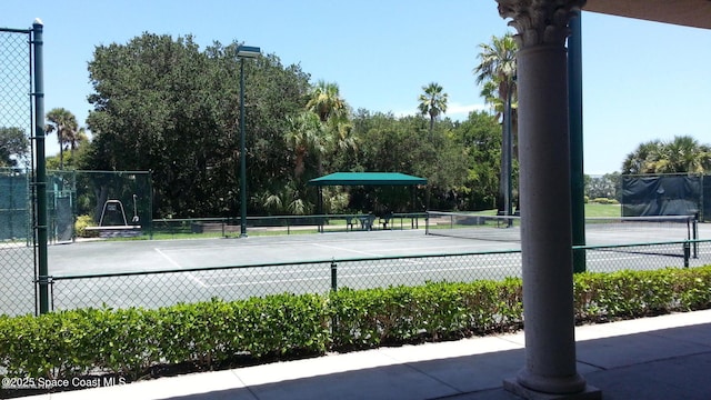 view of tennis court with fence