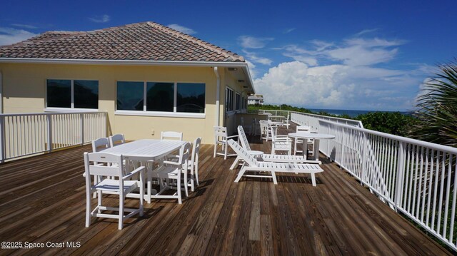 wooden terrace with outdoor dining space