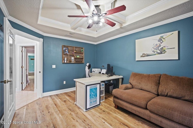 office with ornamental molding, light wood-type flooring, baseboards, and a ceiling fan