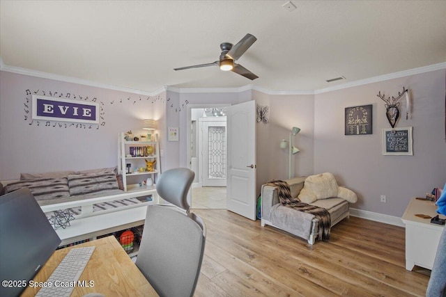 home office with visible vents, ceiling fan, light wood-style flooring, and crown molding